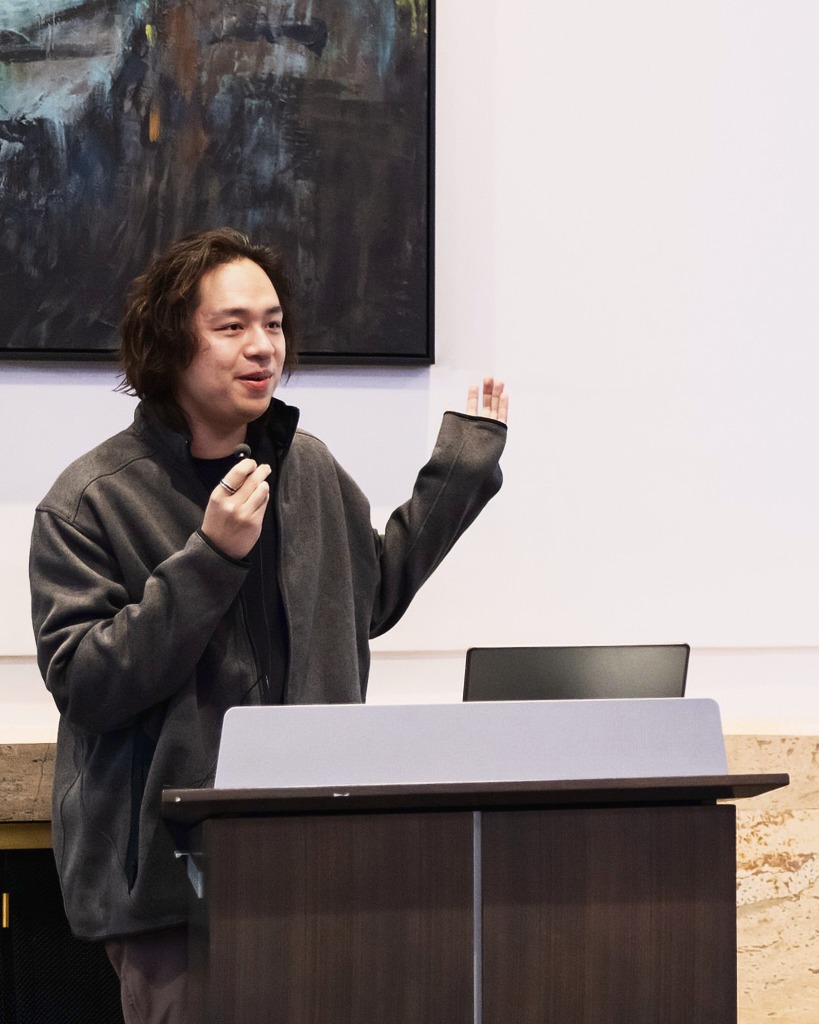 Johnny Chen presenting at a lectern